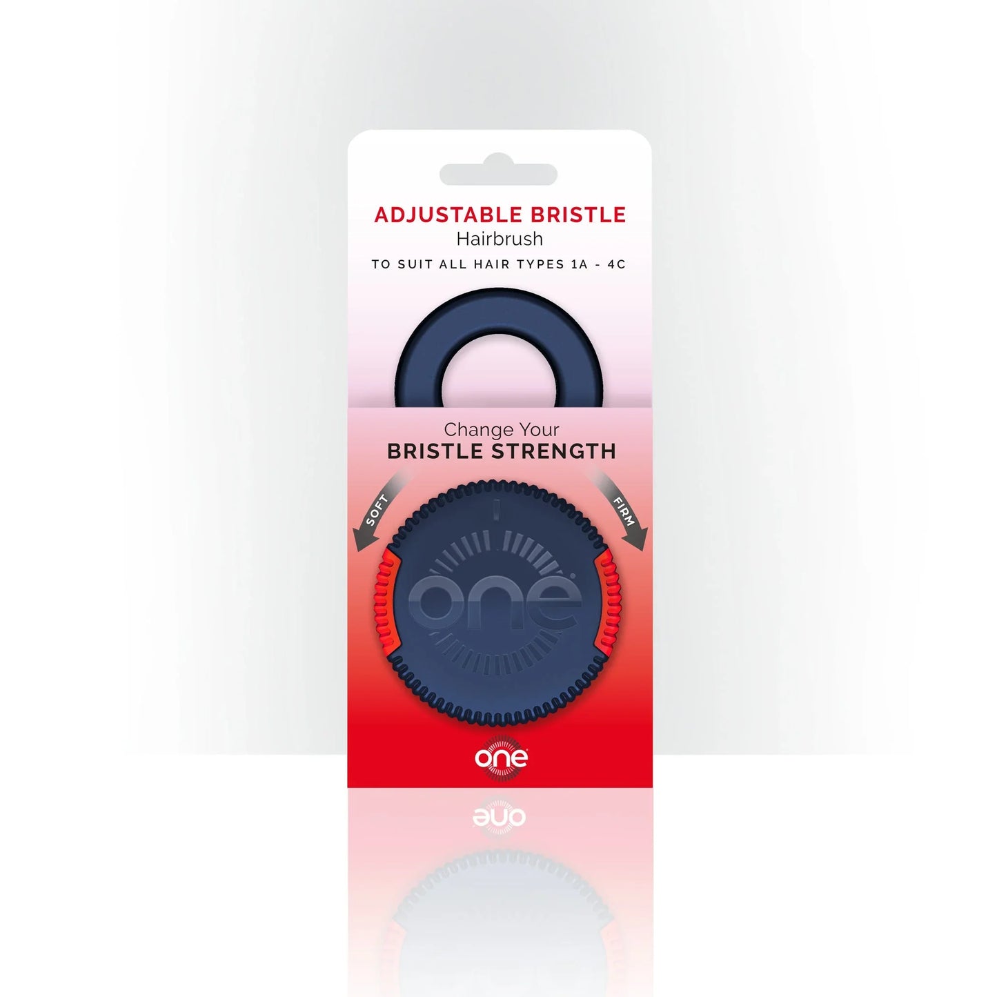 Blue and red One Brush Mini compact hairbrush with 'one' branding in packaging on a white background