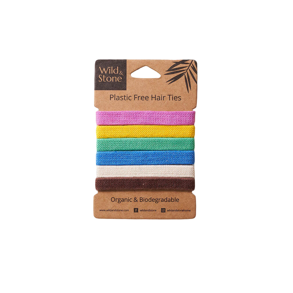 Set of colorful plastic-free hair ties on a cardboard packaging with 'Wild & Stone' branding.