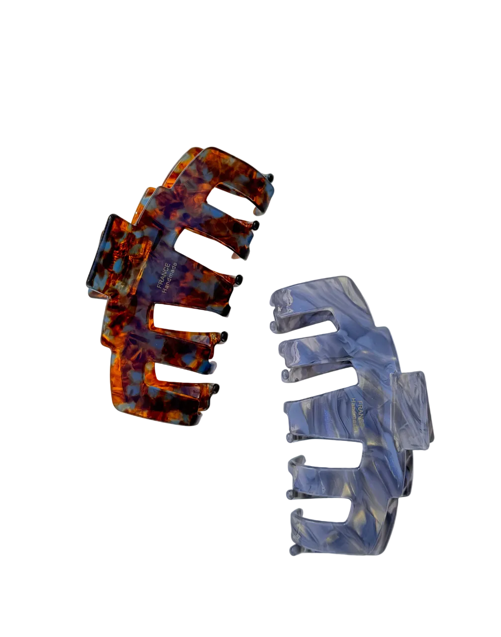 Two hair claw clips, one brown and one light blue, on a light background