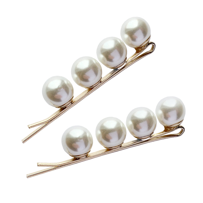 Two pearl hairclips on a white background