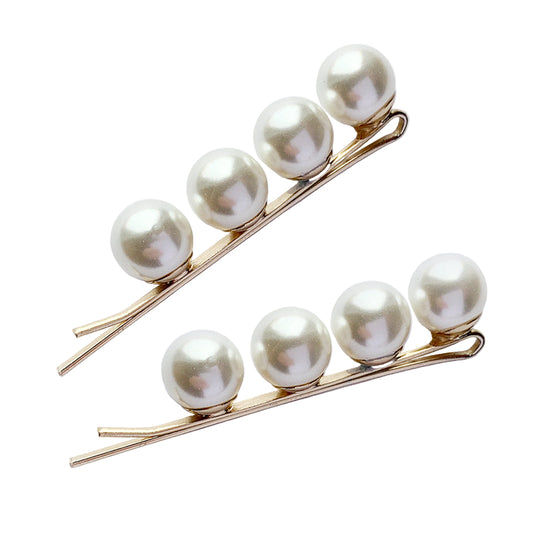 Two pearl hairclips on a white background