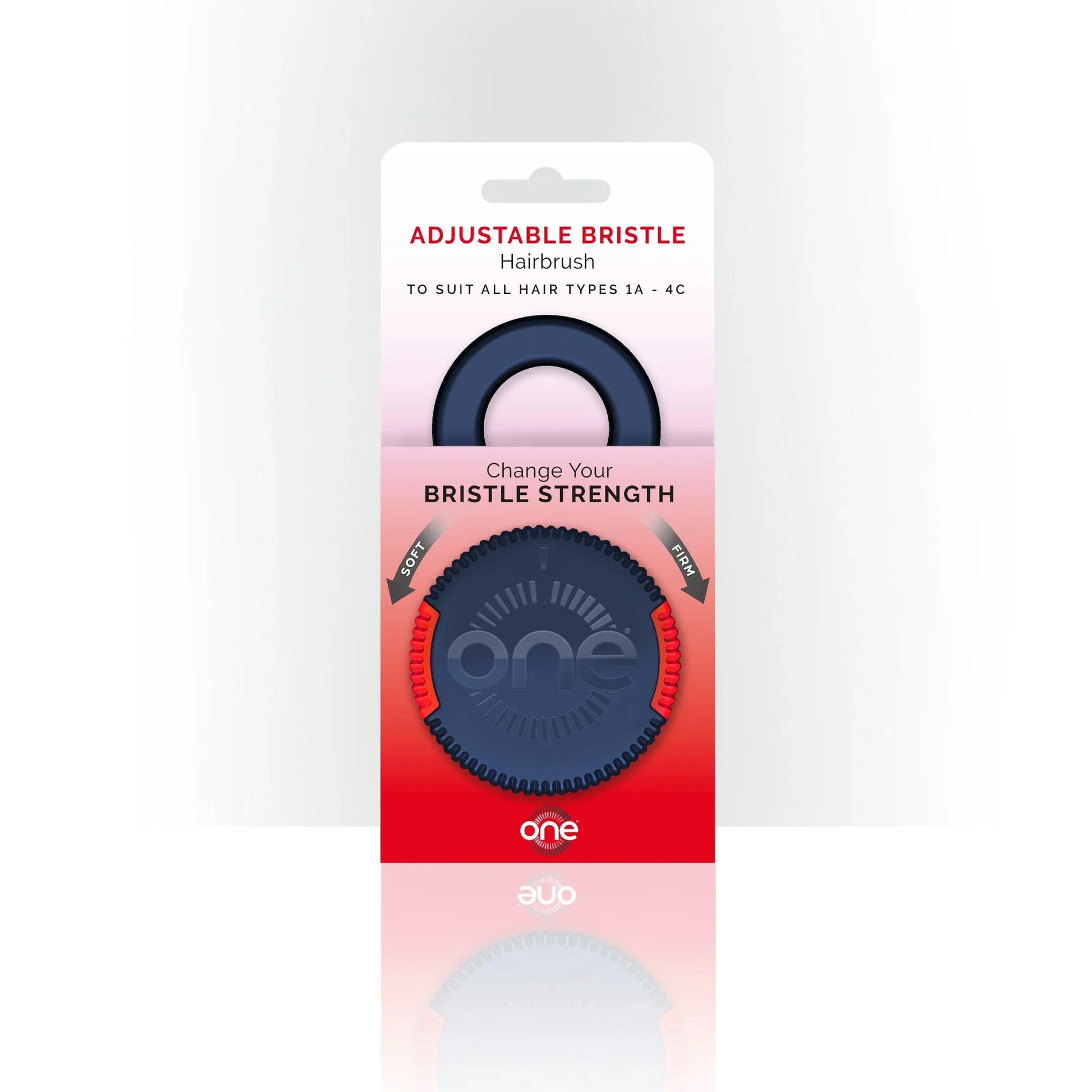 Blue and red One Brush Mini compact hairbrush with 'one' branding in packaging on a white background