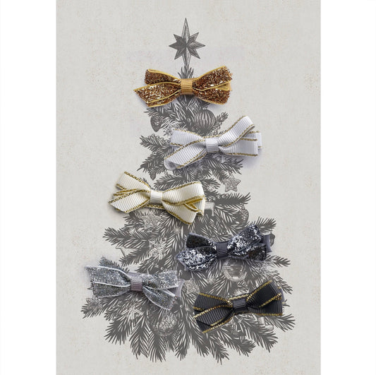 Decorative hair bow set in gold, white, cream, silver and grey, arranged in the shape of a Christmas tree on a textured background.