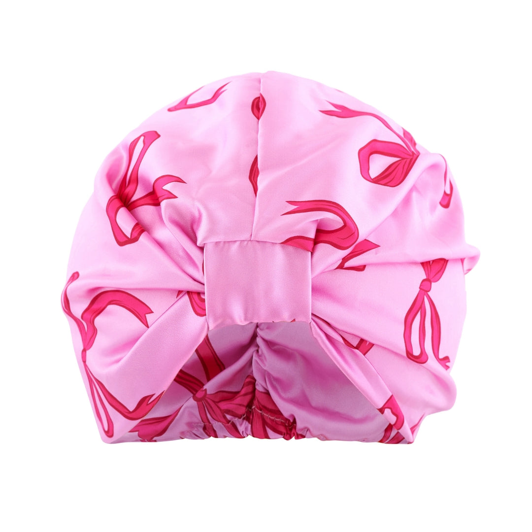 SMUG Pink Bows Satin Sleep Turban with pink bow pattern on a white background